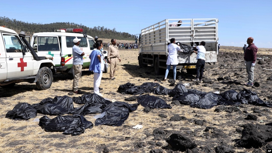 Rescuers remove body bags from the scene of an Ethiopian Airlines flight that crashed shortly after takeoff at Hejere near Bishoftu, or Debre Zeit, some 50 kilometers (31 miles) south of Addis Ababa, in Ethiopia Sunday, March 10, 2019. 