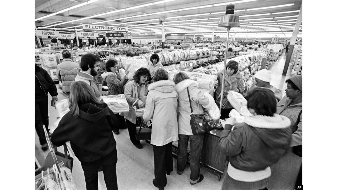 FILE - Kmart shoppers mill around the flashing blue light, sign of the "Blue Light Special," at the first Kmart ever built, in Garden City, Michigan, on March 1, 1982.