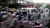 FILE - A screen grab shows people carrying an injured person to a hospital after an attack at Kabul's airport, in Kabul, Afghanistan Aug. 26, 2021. An Islamic State offshoot claimed responsibility for deadly suicide attacks outside the airport.