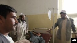 An Afghan police officer who was wounded in a suicide bombing lies in a hospital bed in Baghlan, Afghanistan, November 6, 2011.