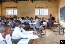 FILE - A teacher gives a lesson to his students at Wampewo Ntakke Secondary School in Kawempe tula village, Kampala, Uganda, on Nov. 4, 2024.