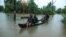TOPSHOT - Residents are being evacuated from their home to a safer place following floods warnings, on a wooden boat in Kochi in the Indian state of Kerala on August 10, 2019. Floods have killed at least 100 people and displaced hundreds of…