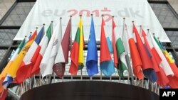 European flags are displayed outside the great hall of the Brussels European Council on June 27, 2012.