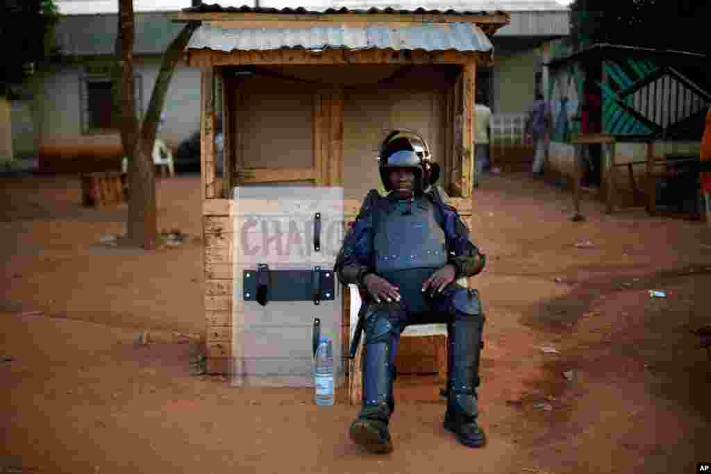 A FOMAC peacekeeper dressed in full riot gear sits in the tense combatant neighborhood of Bangui, Central African Republic, Dec. 16, 2013.