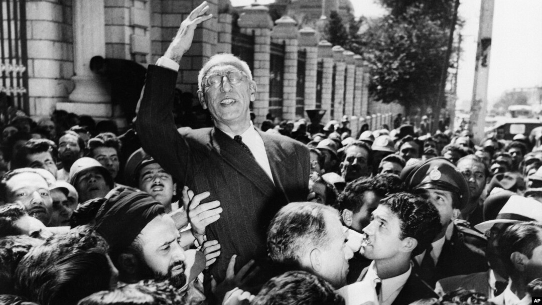 FILE - Prime Minister Mohammed Mosaddegh rides on the shoulders of cheering crowds in Tehran's Majlis Square, outside the parliament building, after reiterating his oil nationalization views to his supporters. Once expunged from its official history, documents outlining the U.S.-backed 1953 coup in Iran have been quietly published by the State Department.