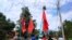 Demonstrators carry flags as they protest the military coup in a village in Launglon township, Myanmar, April 9, 2021. (Courtesy of Dawei Watch/via Reuters)