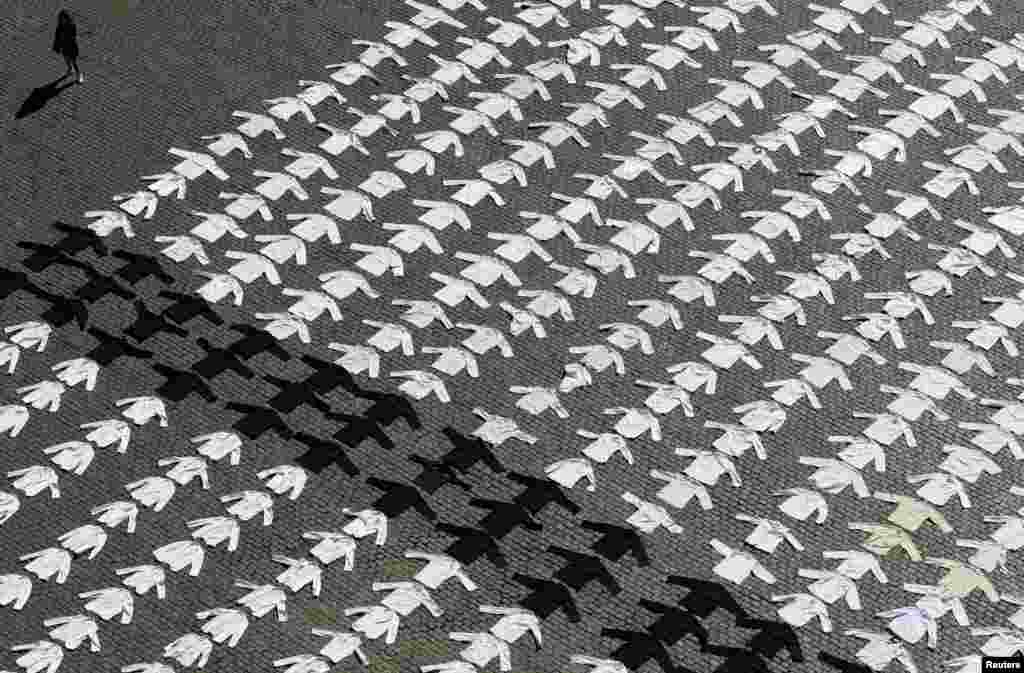 Chef jackets are laid down and displayed as part of a protest by workers of the cafe and restaurant businesses demanding more help from the government, in Brussels, Belgium.