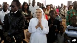 Christian worshippers pray during Christmas mass at a Church in Khartoum, Sudan, Dec. 25, 2013. 