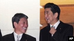 Japanese Prime Minister Shinzo Abe, right, and Toshimitsu Motegi, left, newly appointed Foreign Minister, prepare for a group photo session at the prime minister's official residence in Tokyo Wednesday, Sept. 11, 2019.