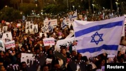 FILE - People take part in a protest against the Israeli government's plan to deport African migrants, in Tel Aviv, Israel, March 24, 2018.