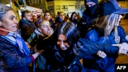 Turkish anti-riot police officers hold a protestor during a demonstration to mark the International Day for Elimination of Violence against Women in Istanbul on November 25, 2024. 