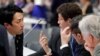 Japan's Environment Minister Shinjiro Koizumi talks with Brazil’s Environment Minister Ricardo Salles at the U.N. Climate Change Conference (COP25) in Madrid, Spain, Dec. 15, 2019. 