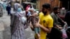 A health worker administers a polio vaccine to a child in a market in the downtown area of Lahore, Pakistan, Sept. 9, 2024.