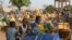 FILE - Children wait for their turn to buy water from a privately-owned water tower, amid an outbreak of the coronavirus disease, in Taabtenga district of Ouagadougou, Burkina Faso, April 3, 2020.