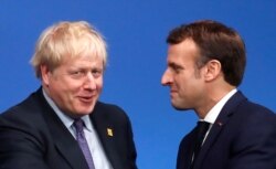 FILE - Britain's Prime Minister Boris Johnson welcomes France's President Emmanuel Macron at the NATO leaders summit in Watford, Britain, Dec. 4, 2019.