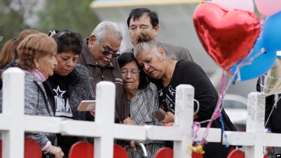 Family and friends gather around a makeshift memorial for the victims of the First Baptist Church shooting at Sutherland Springs Baptist Church in Sutherland Springs, Texas, Nov. 10, 2017. 