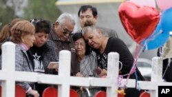 Family and friends gather around a makeshift memorial for the victims of the First Baptist Church shooting at Sutherland Springs Baptist Church in Sutherland Springs, Texas, Nov. 10, 2017. 