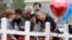 Family and friends gather around a makeshift memorial for the victims of the First Baptist Church shooting at Sutherland Springs Baptist Church in Sutherland Springs, Texas, Nov. 10, 2017. 