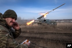 A Ukrainian officer from the 56th Separate Motorized Infantry Mariupol Brigade fires a multiple launch rocket system based on a pickup truck toward Russian positions at the front line, near Bakhmut, Donetsk region, Ukraine, on March 5, 2024.