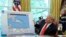 Trump sostiene una tabla de seguimiento de huracanes, mientras habla con los periodistas durante una reunión de información sobre el estado del huracán Dorian.