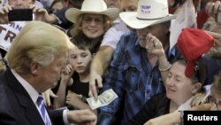 U.S. Republican presidential candidate Donald Trump, shown campaigning in Richmond, Virginia on Oct. 14, 2015, wrote in his book "The Art of the Deal" that "I play to people's fantasies.'' 