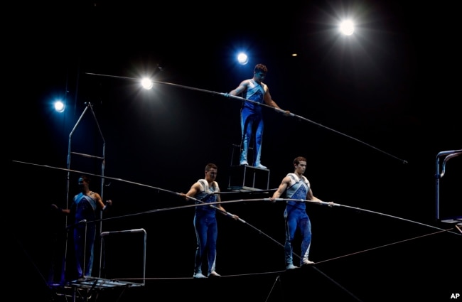 FILE - A Ringling Bros. and Barnum & Bailey high wire act performs in a show in 2017, in Orlando, Florida. (AP Photo/Chris O'Meara)