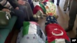 Image made from video provided by TVNET, June 4, 2010, shows bodies shrouded in sheets and flags on board the aid ship Mavi Marmara after a maritime showdown between Israeli commandos and activists on board the ship.