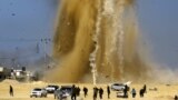 Palestinians run for cover as smoke rises following an Israeli airstrike on a Hamas post, in the northern Gaza Strip. Israel struck a number of Hamas positions in Gaza after a &quot;projectile&quot; fired from the Palestinian enclave crashed in a border area, the Israeli army said.