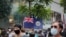 FILE - A man displays the Hong Kong colonial flag on the anniversary of Hong Kong's handover to China from Britain, in Hong Kong, July 1, 2020.
