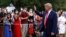 FILE - President Donald Trump greets visitors as he walks on the South Lawn of the White House during a "Salute to America" event, July 4, 2020.