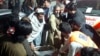 Rescue workers and volunteers help victims of a bomb explosion upon their arrival at a hospital in Bannu, Pakistan, on March 4, 2025.