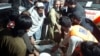 Rescue workers and volunteers help victims of a bomb explosion upon their arrival at a hospital in Bannu, Pakistan, March 4, 2025.