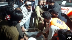 Rescue workers and volunteers help victims of a bomb explosion upon their arrival at a hospital in Bannu, Pakistan, March 4, 2025.