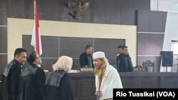 Bahar Smith nampak berbincang sejenak dengan Jaksa Penuntut Umum (JPU) usai menerima vonis tiga tahun penjara dalam sidang di Bandung, (Selasa 9/7/2019) siang. (Foto: VOA/Rio Tuasikal)