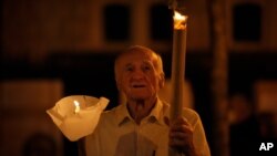 A man holds a torch during a procession joined by tens of thousands in Budapest, Hungary, Sept. 11, 2021, the day before the final Mass of International Eucharistic Congress on which will be attended by Pope Francis. 