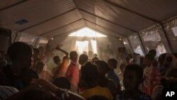 Tigray refugee children sing and dance inside a tent run by UNICEF for children's activities, in Umm Rakouba refugee camp in Qadarif, eastern Sudan, Dec. 10, 2020.