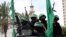 Masked militants from the Izzedine al-Qassam Brigades, a military wing of Hamas, ride vehicles as they commemorate the 30th anniversary of their group, in Gaza City, Dec. 13, 2017. 