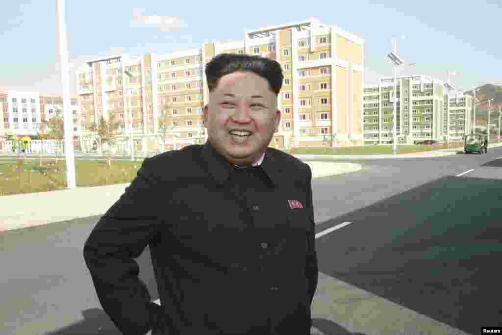 North Korean leader Kim Jong Un poses outside the newly built Wisong Scientists Residential District in this undated photo released by North Korea&#39;s Korean Central News Agency (KCNA) in Pyongyang October 14, 2014. 