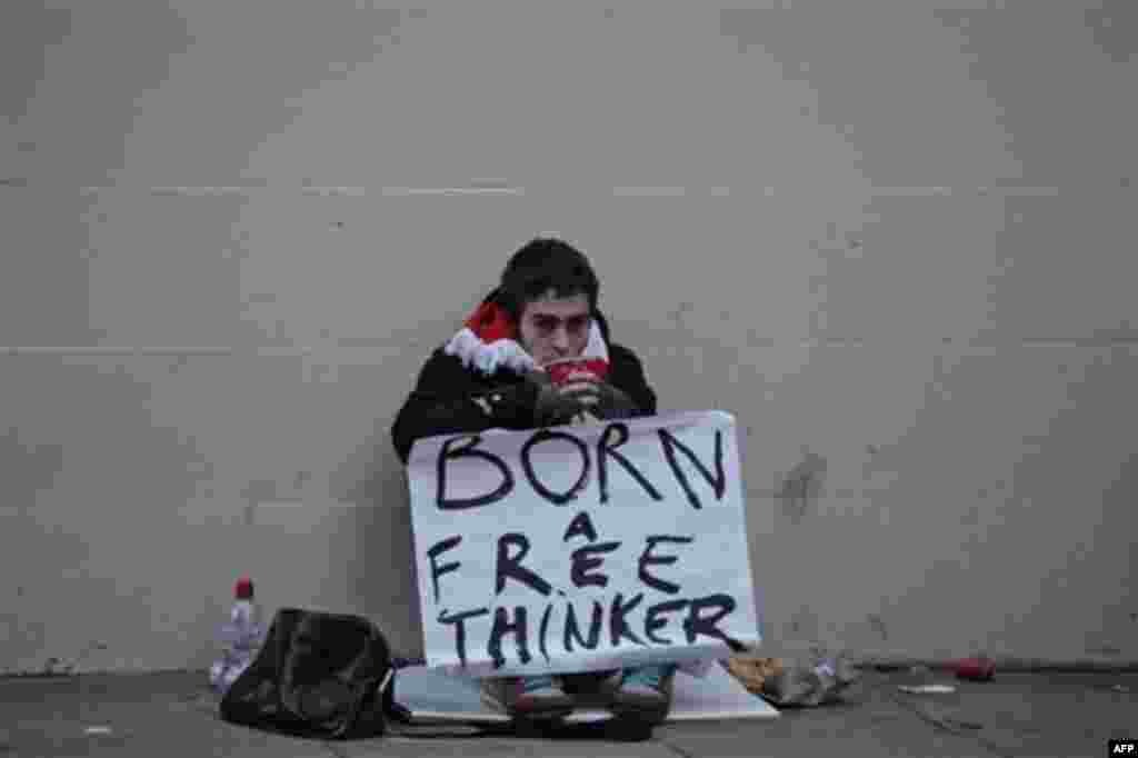 A supporter of Wikileaks founder Julian Assange waits outside the City of Westminster Magistrates Court in London, following Assange bail hearing, Tuesday, Dec. 14, 2010. Julian Assange was granted bail at the City of Westminster Magistrates Court in Lon