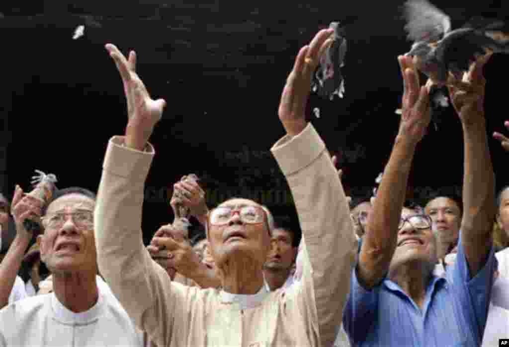 Hla Pe, from left, Soe Myint and Win Tin senior members of the National League for Democracy, led by Myanmar's detained pro-democracy leader Aung San Suu Kyi, release birds as a gesture of freedom for Suu Kyi during a ceremony marking the 19th anniversary