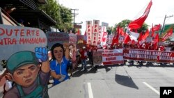 Women carry burning torches as they march during a demonstration against the military coup in Yangon, Myanmar.