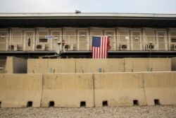 FILE - A U.S. flag hangs off of a housing unit inside of Bagram Air Field in the Parwan province of Afghanistan, Jan. 2, 2015.