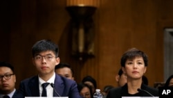  Hong Kong activists Joshua Wong, left, and Denise Ho, attend a congressional hearing about the protests in Hong Kong, Sept. 17, 2019, on Capitol Hill in Washington. 