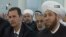 An image grab taken from the state-run Syrian TV shows Syria's embattled President Bashar al-Assad (L) siting next to Grand Mufti Ahmed Hassun during a prayer to mark the birth of Islam's Prophet Mohammed in Damascus, January 24, 2013. 