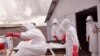 FILE - health workers wearing Ebola protective gear remove the body of a man they suspect died from the Ebola virus, at a USAID, American aid Ebola treatment center on the outskirts of Monrovia, Liberia, Nov. 28, 2014.