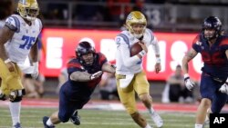 UCLA quarterback Austin Burton (12) runs during an NCAA college football game against Arizona, Sept. 28, 2019. A bill signed Monday in California will allow student athletes to use their "name, image, or likeness" to earn compensation.