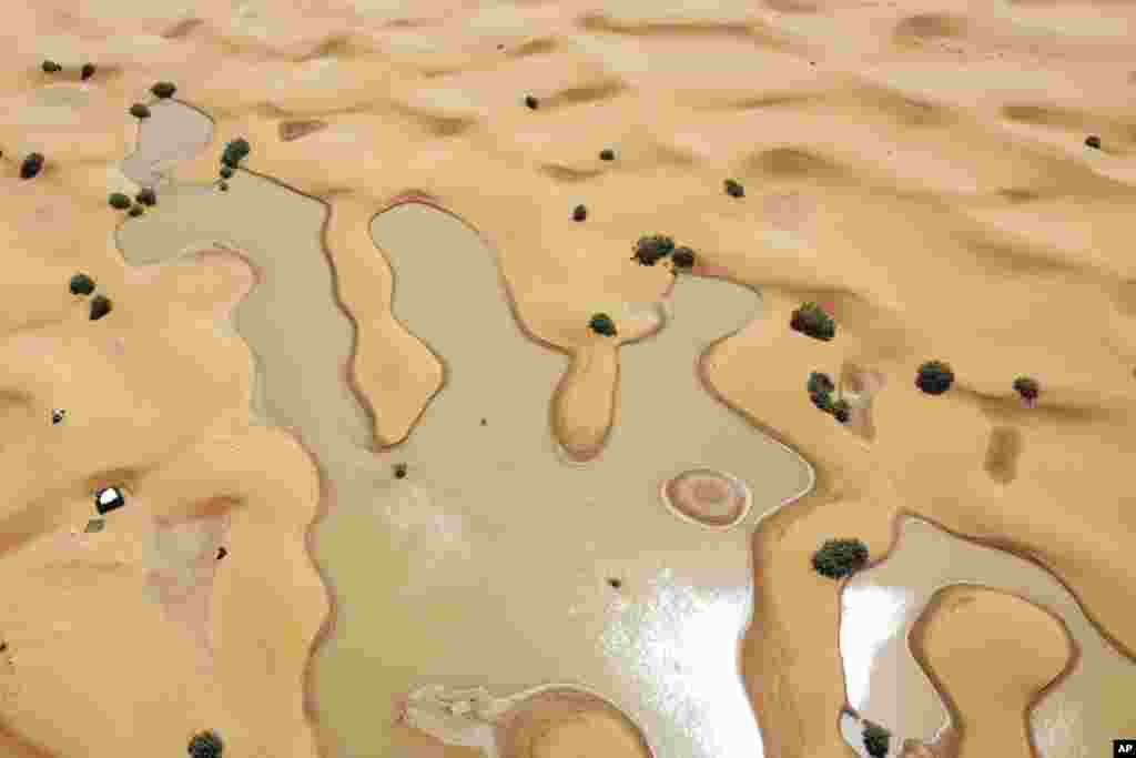 A view of lakes caused by heavy rainfall between sand dunes in the desert town of Merzouga, near Rachidia, southeastern Morocco.