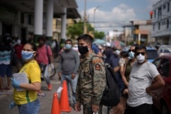 People wait in line to buy supplies amid the spread of the coronavirus disease in Guayaquil, Ecuador, April 2, 2020.
