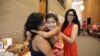 Gayatri “Genny” Joshi greets the daughter of her fellow SAYHU co-founder at the summer institute. (E. Sarai/VOA)