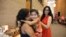 Gayatri “Genny” Joshi greets the daughter of her fellow SAYHU co-founder at the summer institute. (E. Sarai/VOA)